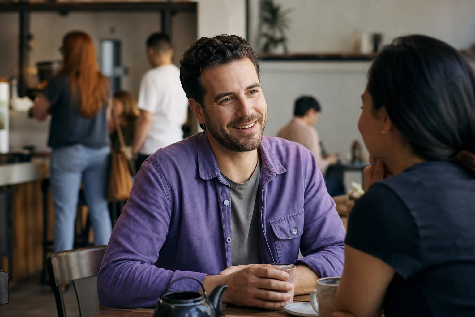 Two men talking over coffee at a relaxed Lothian café